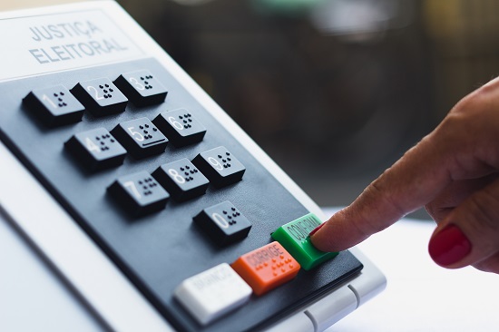 November 16, 2020, Brazil. In this photo illustration a woman simulates a vote in the electronic ballot box used in the elections of Brazil.